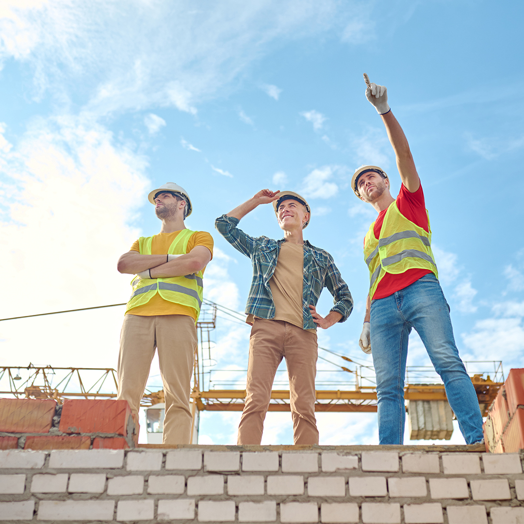 men-standing-brick-wall-building-construction